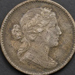 The coin is too close to the frame, cutting off part of its rim.
