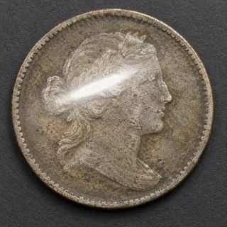 A bright reflection falls across the coin surface.