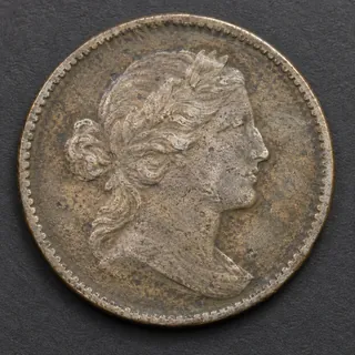 Sharp front view of a worn coin with the full rim visible.